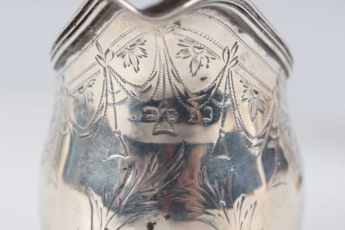 A George III silver oval cream jug, engraved with festoon tassel decoration, London 1801, height 9. - Image 3 of 6