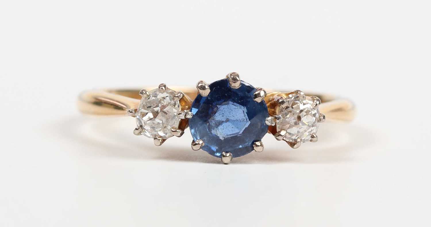 A gold, platinum, sapphire and diamond ring, claw set with a circular cut sapphire between two old - Image 2 of 5