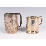 A late Victorian Arts and Crafts silver christening mug, the cylindrical body decorated in relief