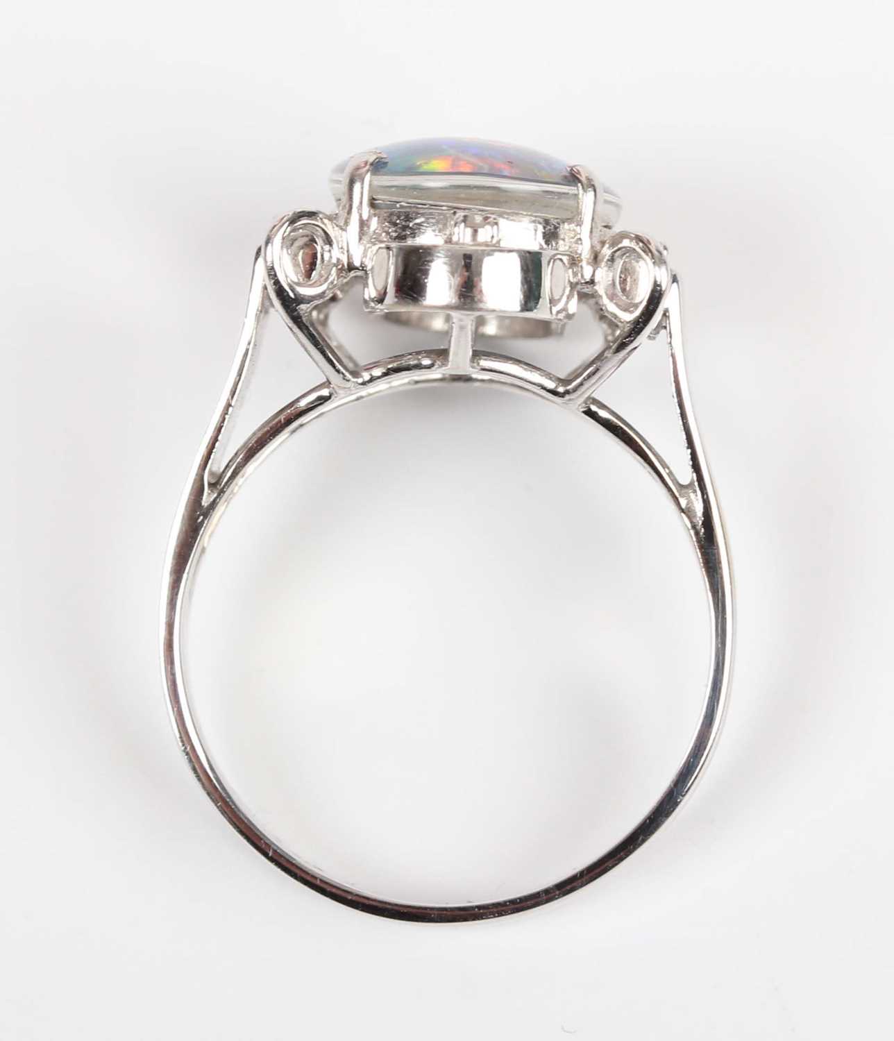 A white gold, opal triplet and diamond ring, claw set with the oval opal triplet in an openwork - Image 4 of 5