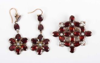 A gold, garnet and seed pearl brooch, probably mid-19th century, in a quatrefoil shaped design,