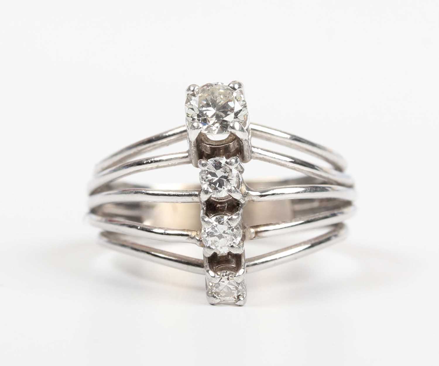A diamond ring, claw set with a row of four circular cut diamonds between split sides, unmarked, - Image 2 of 5