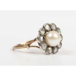 A gold, diamond and cultured pearl cluster ring, mounted with the single cultured pearl within a