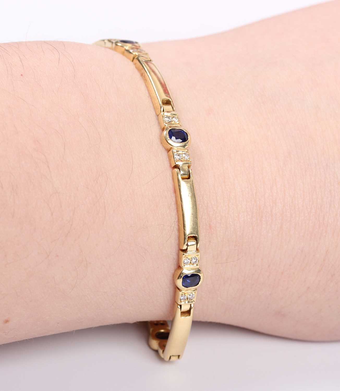 A gold, sapphire and diamond bracelet, mounted with oval cut sapphires between pairs of circular cut - Image 3 of 3