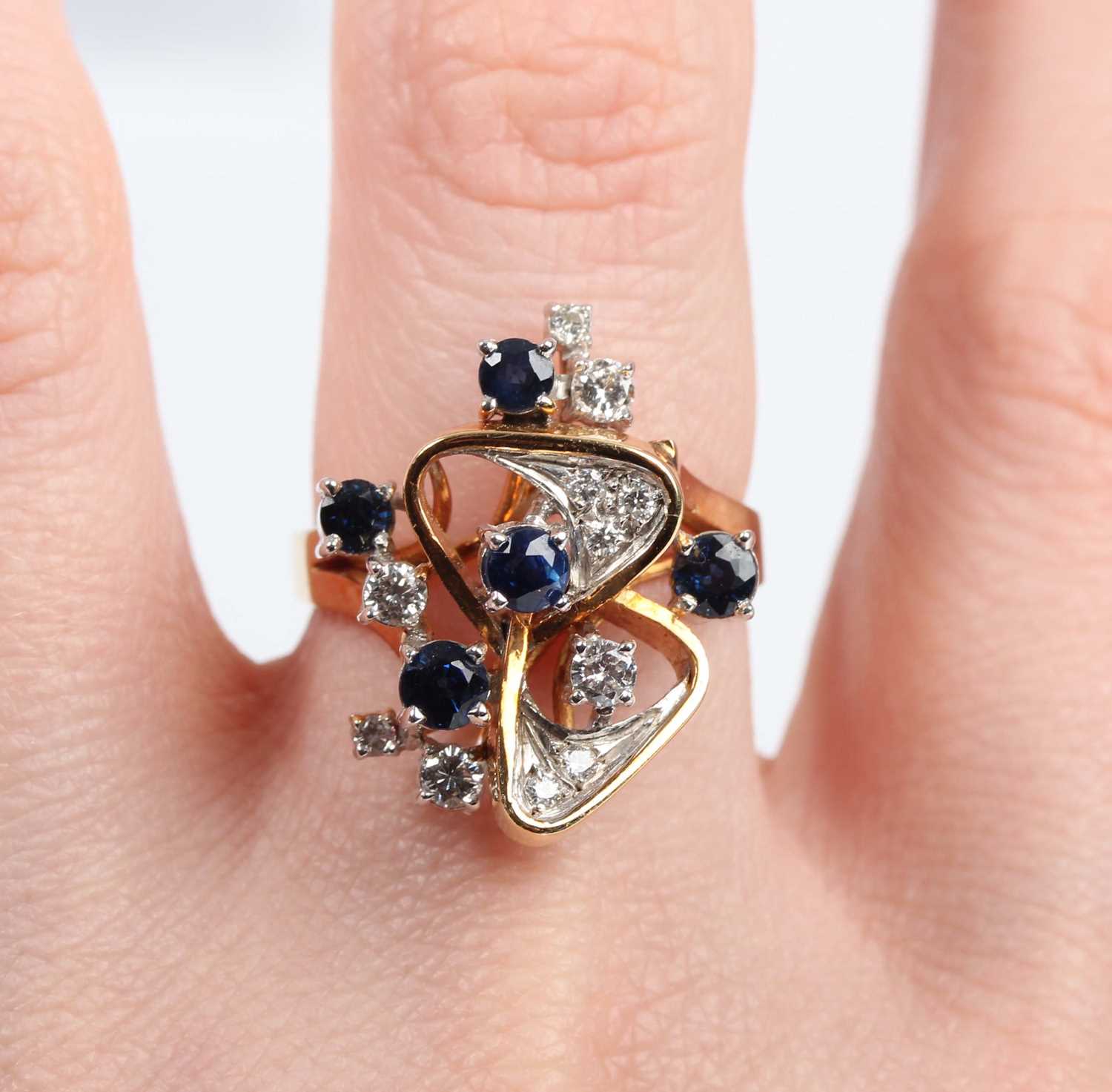 A gold, sapphire and diamond ring in an abstract design, claw set with five circular cut - Image 5 of 5