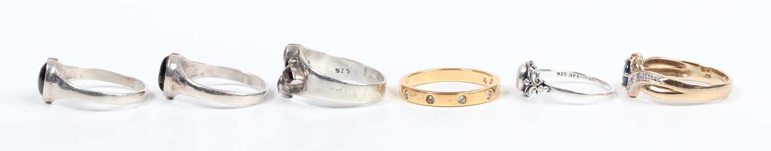 A 9ct gold, sapphire and diamond ring, claw set with the oval cut sapphire between diamond three - Image 3 of 4