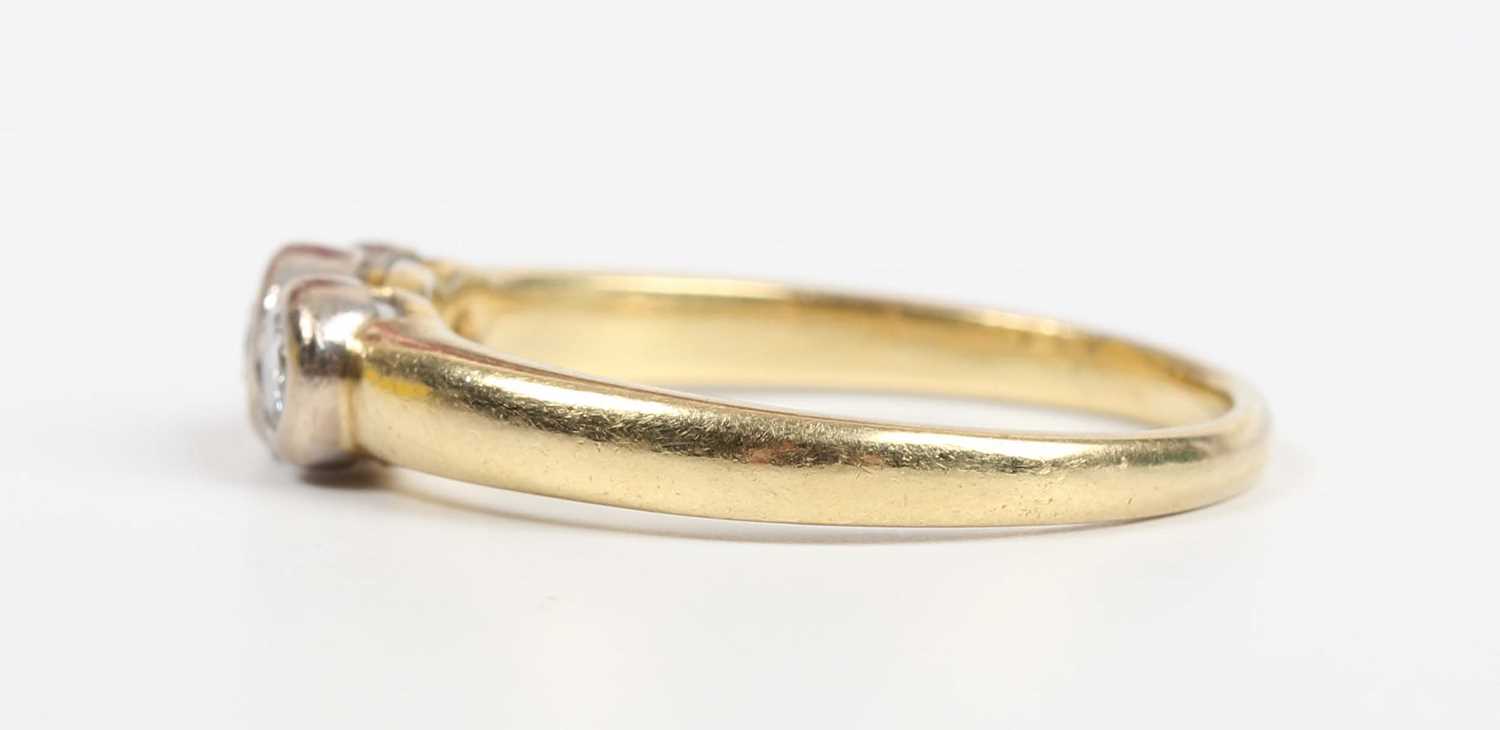 An 18ct gold and diamond three stone ring, collet set with a row of circular cut diamonds, Sheffield - Image 3 of 5