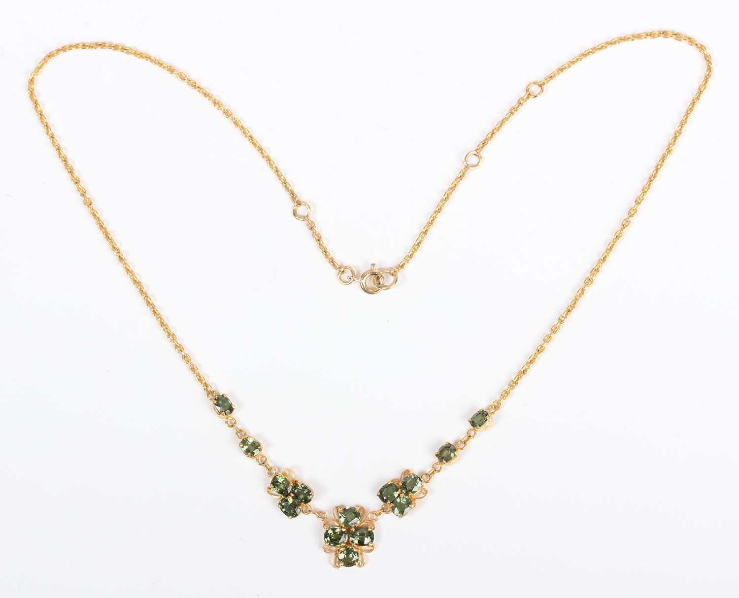 A gold and green sapphire necklace, the front in a scrolling design mounted with oval cut green - Image 2 of 3