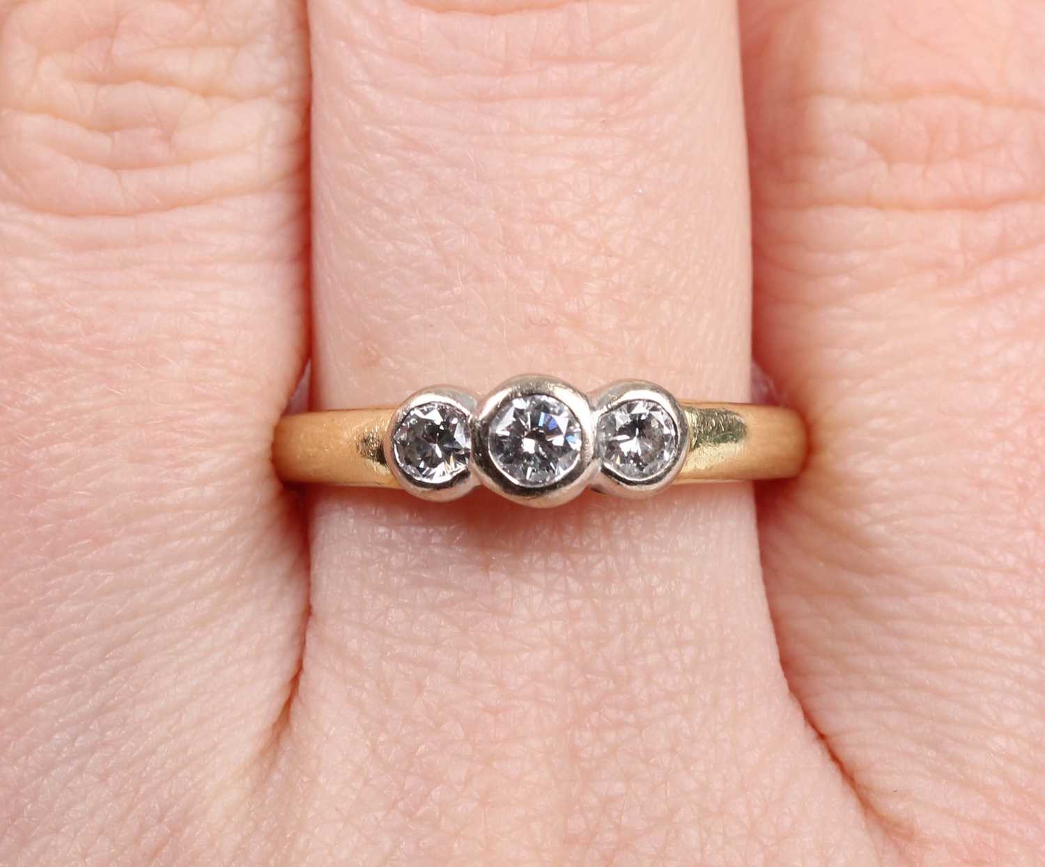 An 18ct gold and diamond three stone ring, collet set with a row of circular cut diamonds, Sheffield - Image 5 of 5