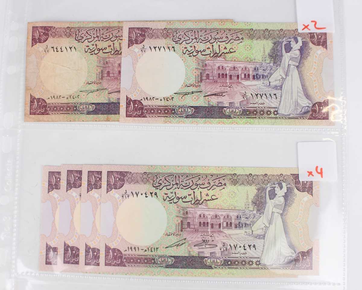 A collection of approximately fifty mid to late 20th century Syrian banknotes, within an album. - Image 3 of 9