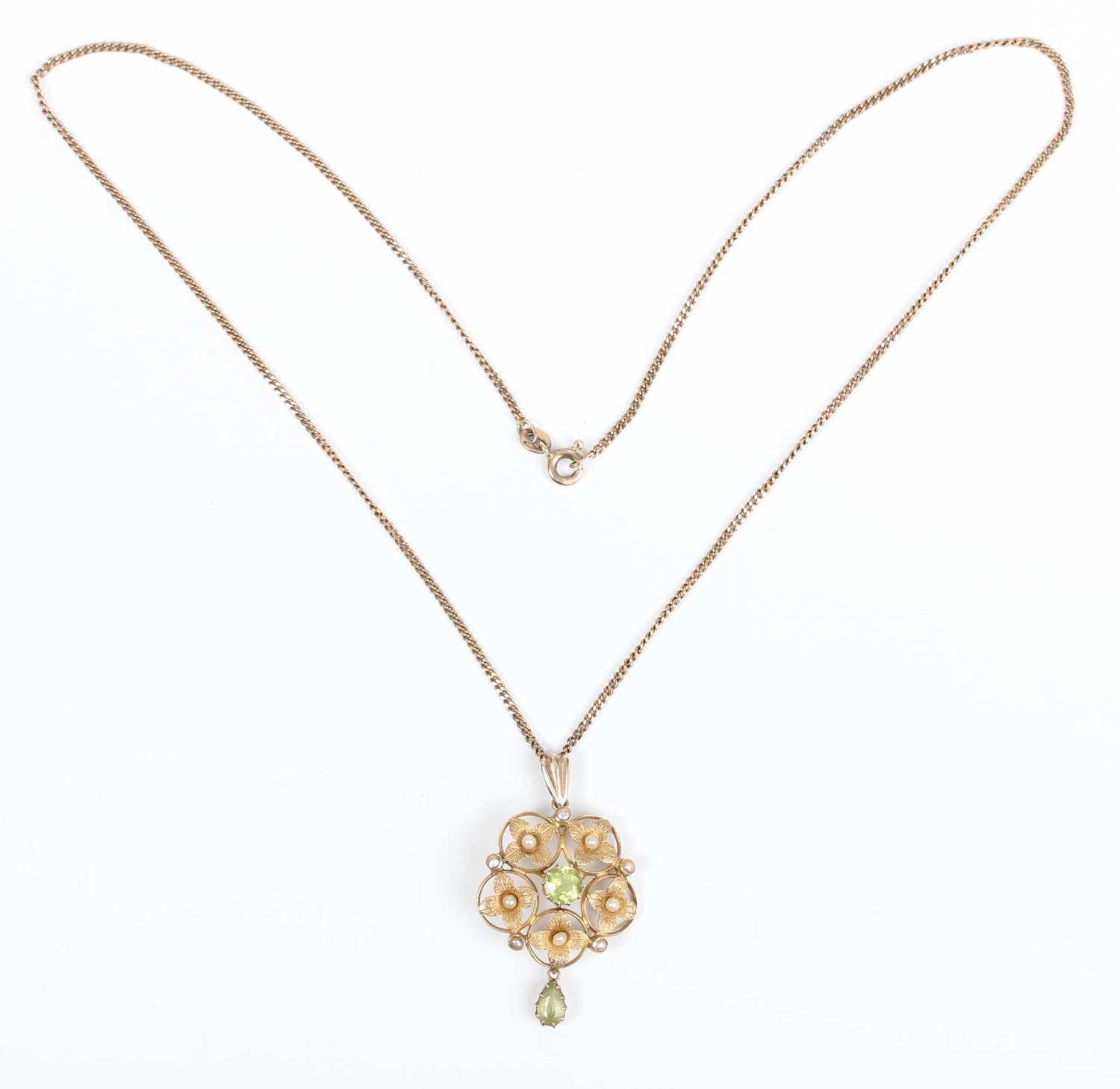 An Edwardian gold, peridot and seed pearl pendant in a cinquefoil shaped design, claw set with the - Image 2 of 3