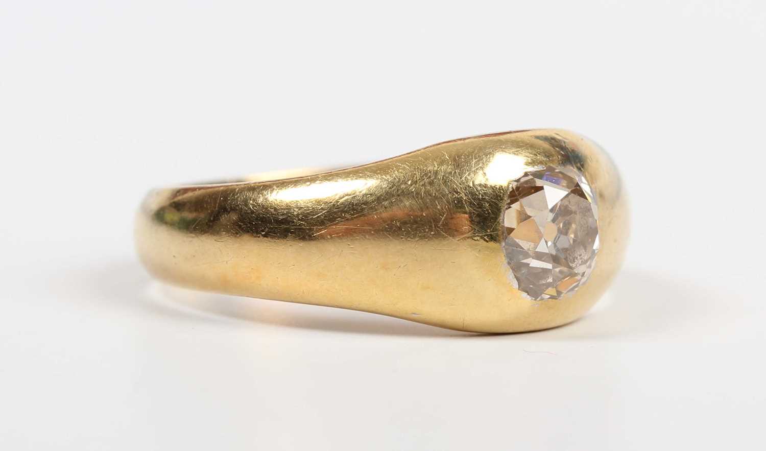 A gold and diamond single stone ring, gypsy set with an old cut diamond, traces of inscription