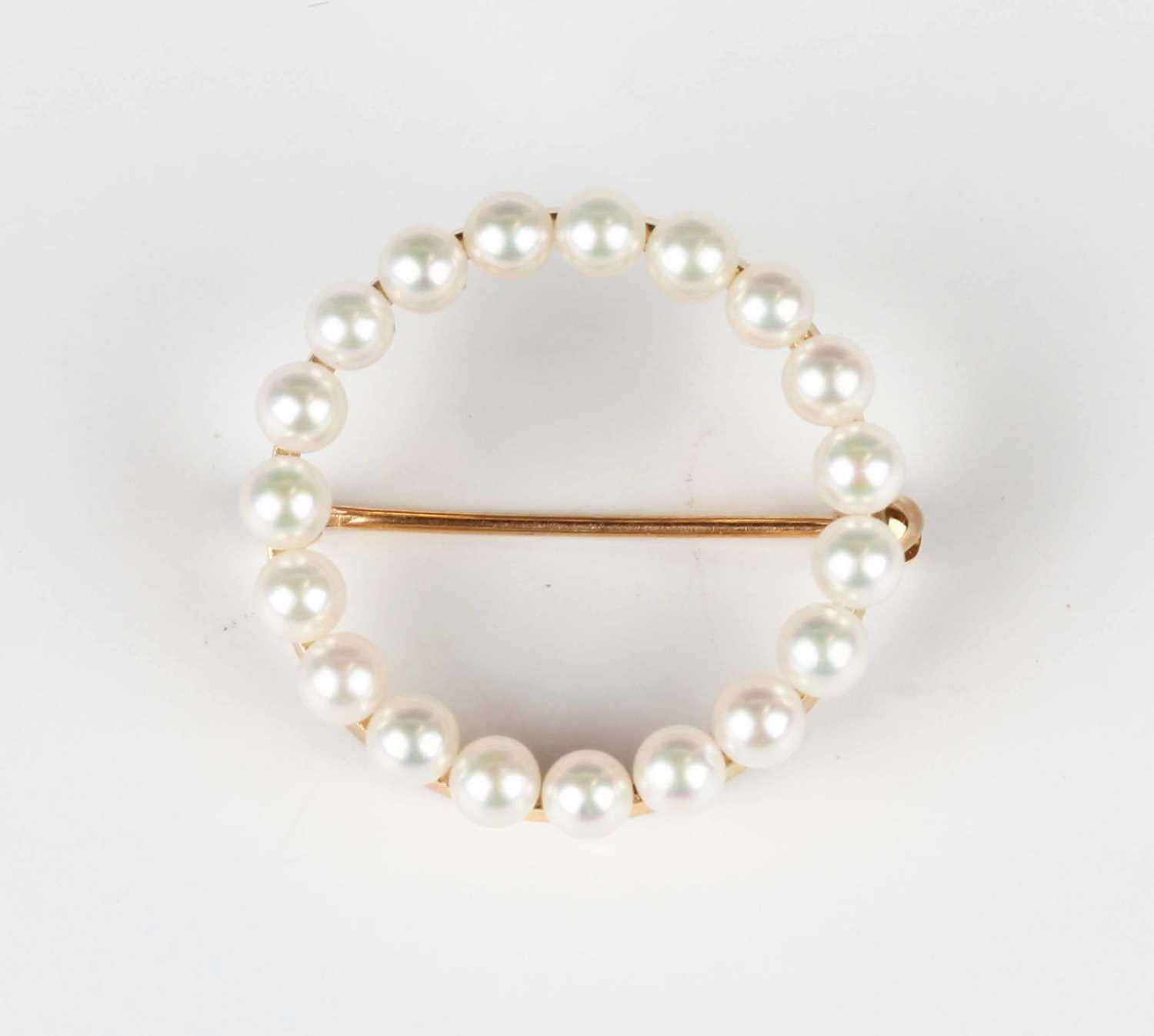 A gold and cultured pearl brooch in a circular design, detailed '14K', weight 2.5g, diameter 2.1cm.