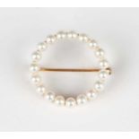 A gold and cultured pearl brooch in a circular design, detailed '14K', weight 2.5g, diameter 2.1cm.