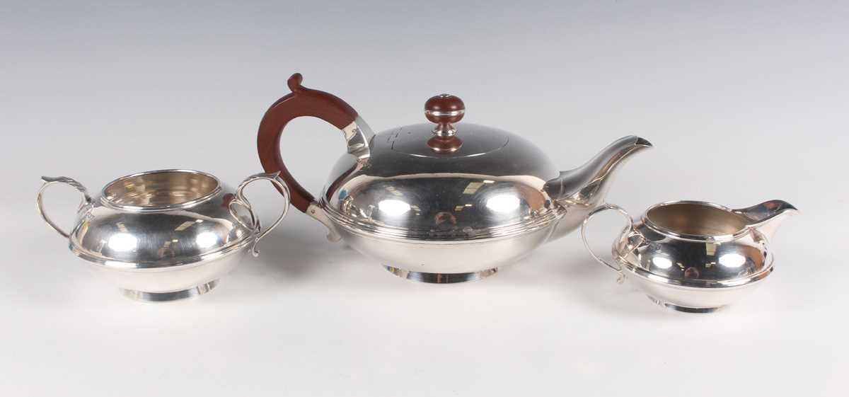 An Art Deco silver three-piece tea set, comprising teapot, milk jug and sugar bowl, each of