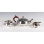 An Art Deco silver three-piece tea set, comprising teapot, milk jug and sugar bowl, each of