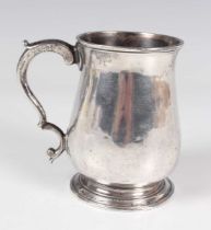 A George III silver tankard of baluster form with scroll handle, London 1780 by Thomas Wallis I,