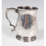 A George III silver tankard of baluster form with scroll handle, London 1780 by Thomas Wallis I,