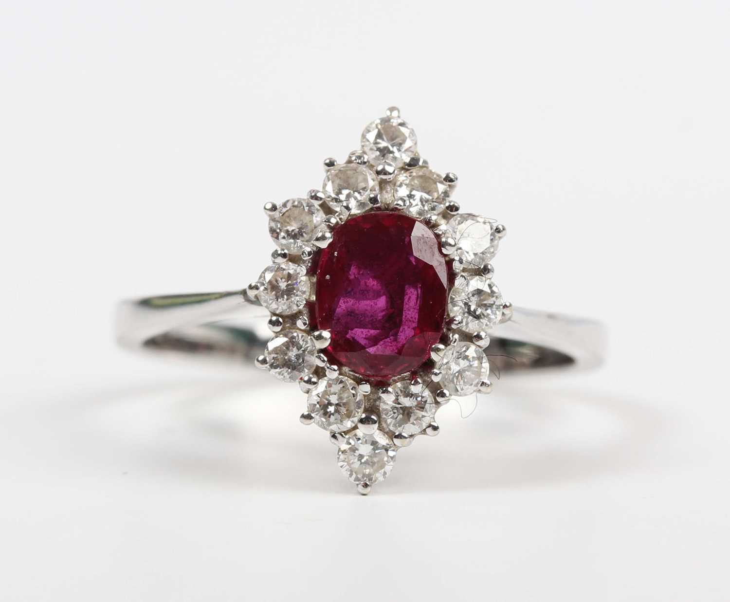 A ruby and diamond cluster ring, claw set with the oval cut ruby within a marquise shaped surround - Image 2 of 5