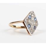 A gold, diamond and blue gem set lozenge shaped ring, mounted with four cushion cut blue gemstones