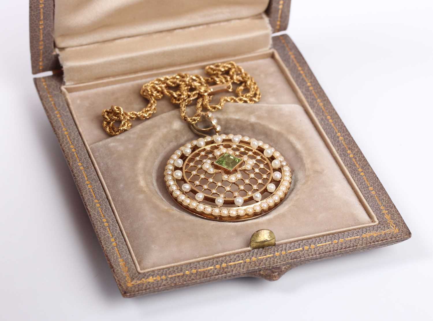 An Edwardian gold, peridot and seed pearl circular pendant of openwork design, mounted with the - Image 4 of 5