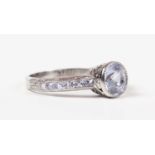 A platinum and grey sapphire ring, collet set with the principal cushion shaped grey sapphire