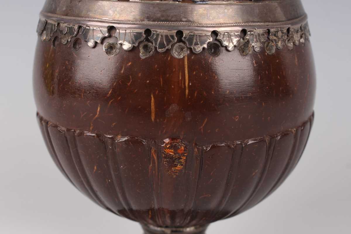 A George III plate mounted coconut cup, the rim cast and pierced with a band of flowers and - Image 2 of 4