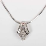 A 9ct white gold and diamond pendant, designed as a lozenge shaped cluster, mounted with circular
