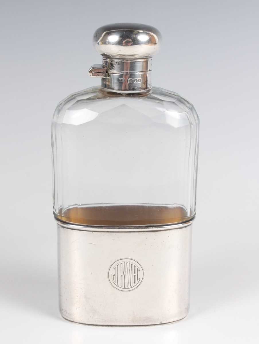 An Edwardian silver mounted faceted cut glass hip flask with detachable cup, London 1904 by