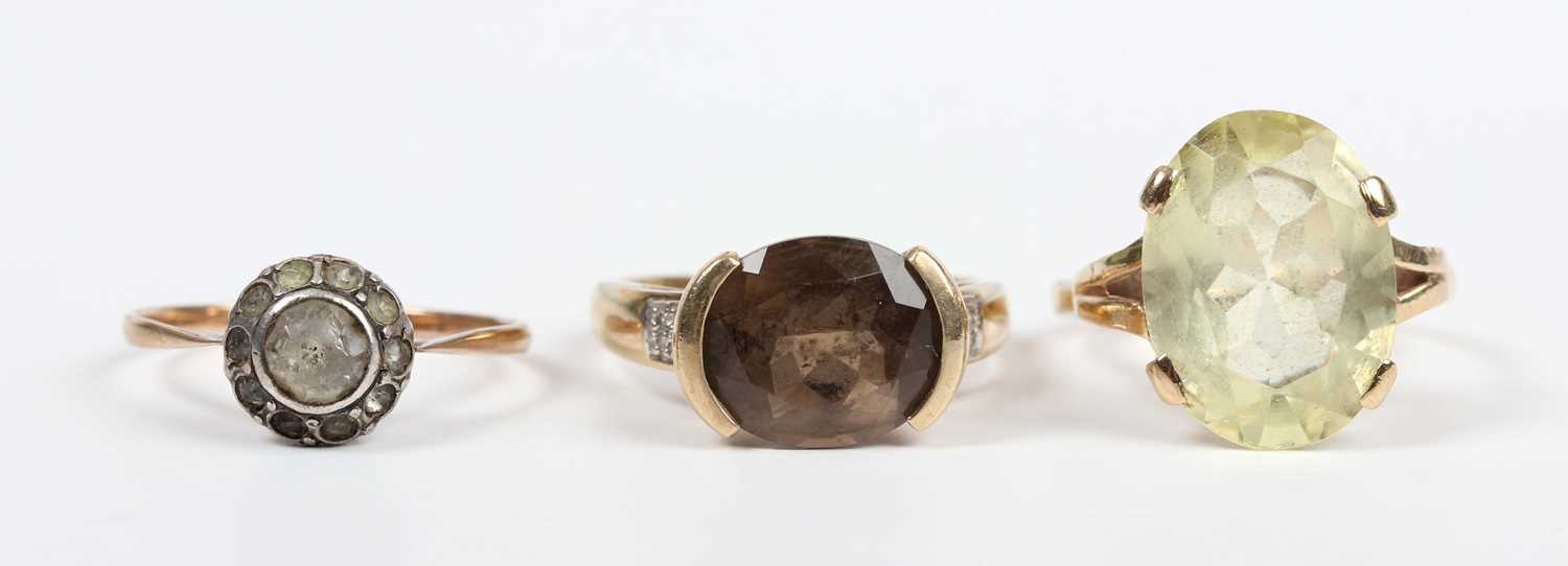 A gold, smoky quartz and diamond ring, mounted with an oval cut smoky quartz between diamond four - Image 2 of 4