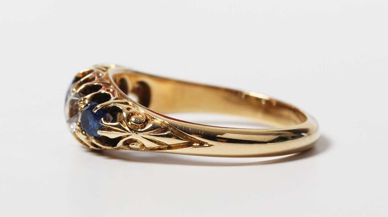 A gold, sapphire and diamond ring, mounted with three sapphires alternating with two old cut - Image 3 of 5