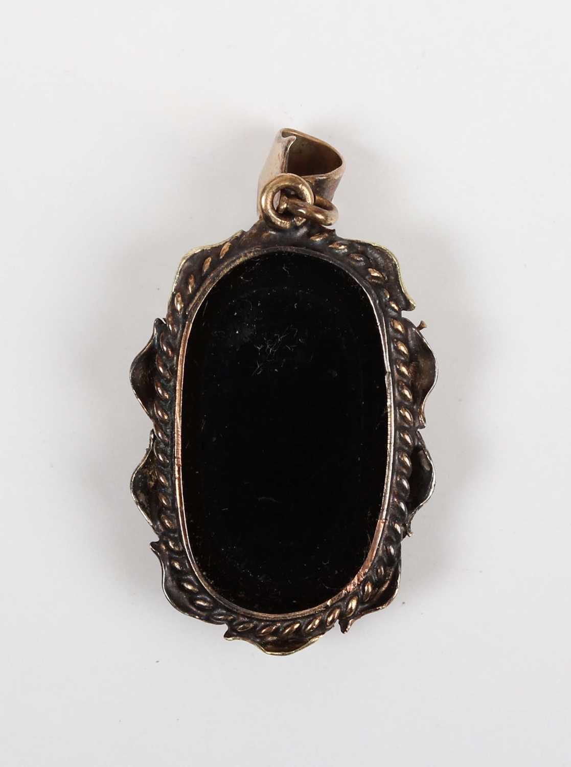 A gold mounted black opal doublet single stone pendant, with a foliate surround, detailed ‘9ct’, - Image 2 of 3