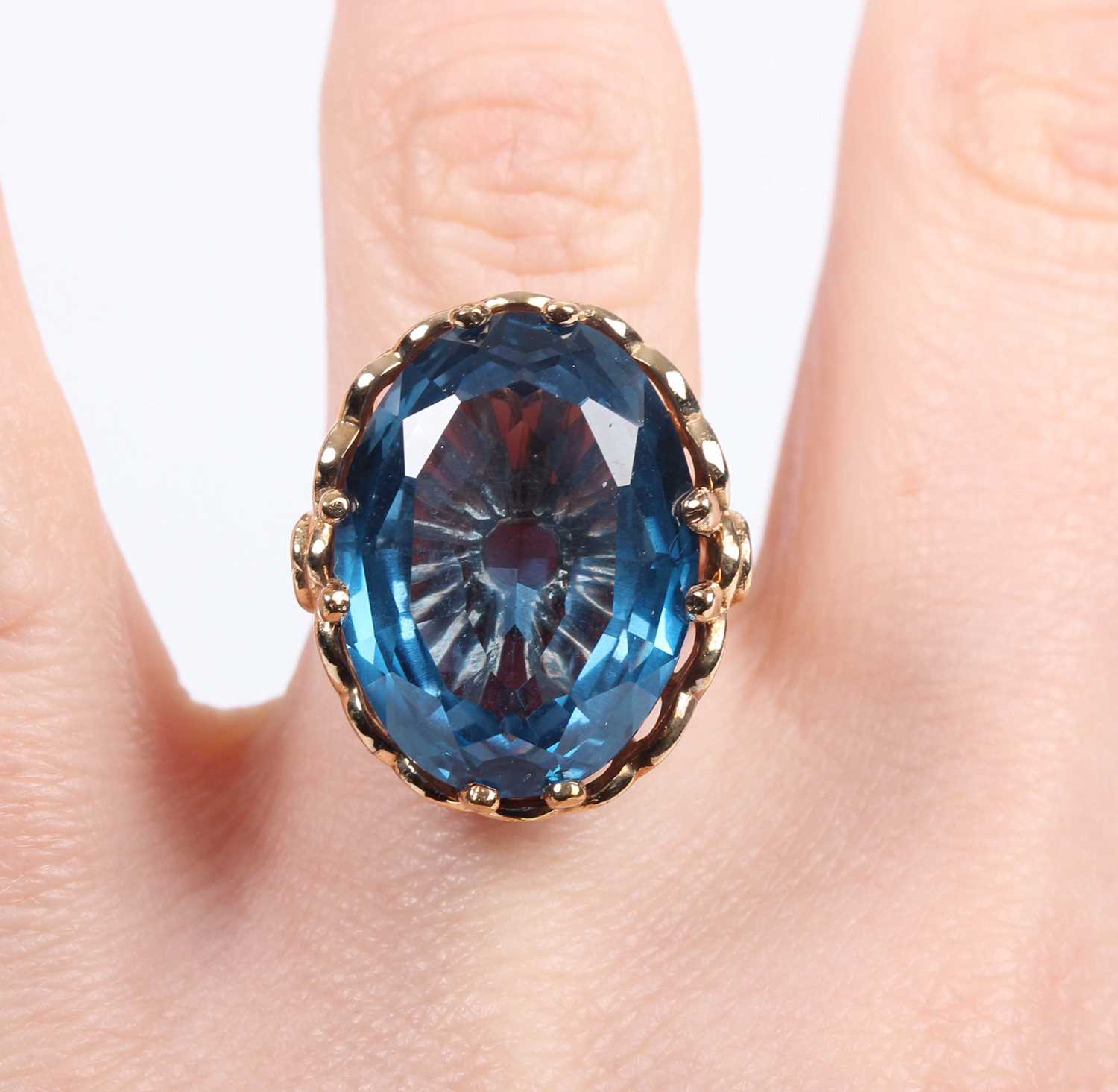 A 9ct gold ring, claw set with a large oval cut synthetic blue spinel, London 2009, weight 9g, - Image 5 of 5