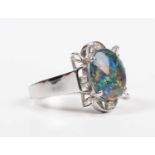 A white gold, opal triplet and diamond ring, claw set with the oval opal triplet in an openwork