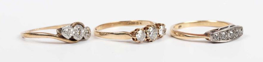 A gold and diamond ring, mounted with a graduated row of five old cut diamonds, indistinct mark,