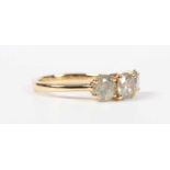 An 18ct gold and diamond three stone ring, mounted with a graduated row of circular cut light