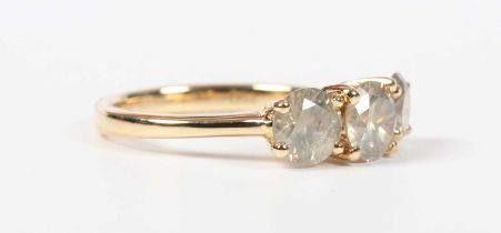An 18ct gold and diamond three stone ring, mounted with a graduated row of circular cut light