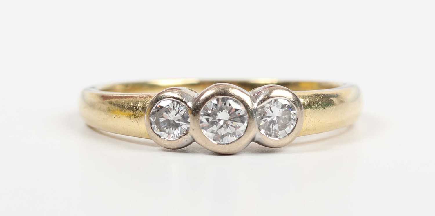 An 18ct gold and diamond three stone ring, collet set with a row of circular cut diamonds, Sheffield - Image 2 of 5