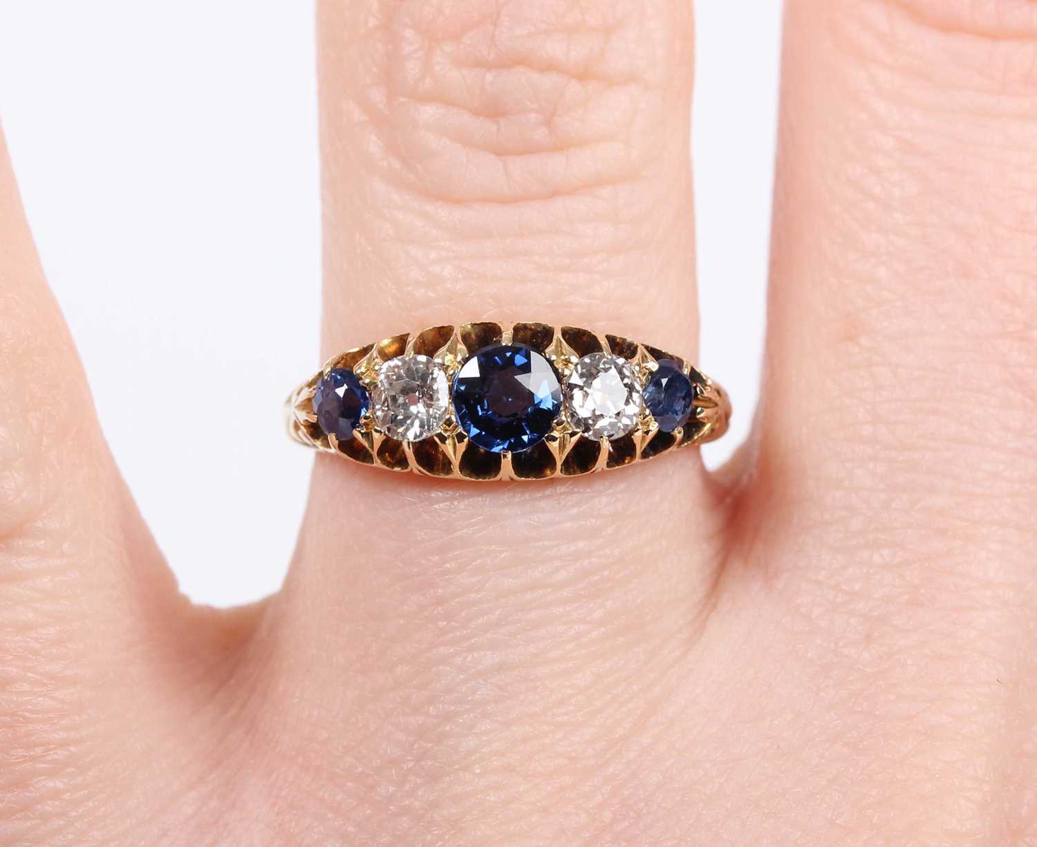 A gold, sapphire and diamond ring, mounted with three sapphires alternating with two old cut - Image 5 of 5