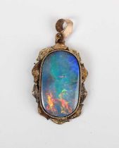 A gold mounted black opal doublet single stone pendant, with a foliate surround, detailed ‘9ct’,