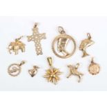 Two 9ct gold charms, comprising a heart and a cross, four gold charms, including a Nefertiti head,