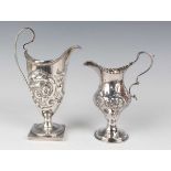 A George III silver baluster cream jug, chased with a beaded cartouche flanked by flowers and