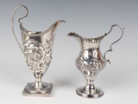 A George III silver baluster cream jug, chased with a beaded cartouche flanked by flowers and