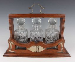 A James Dixon & Sons plate mounted oak three-bottle tantalus of rectangular form with carrying