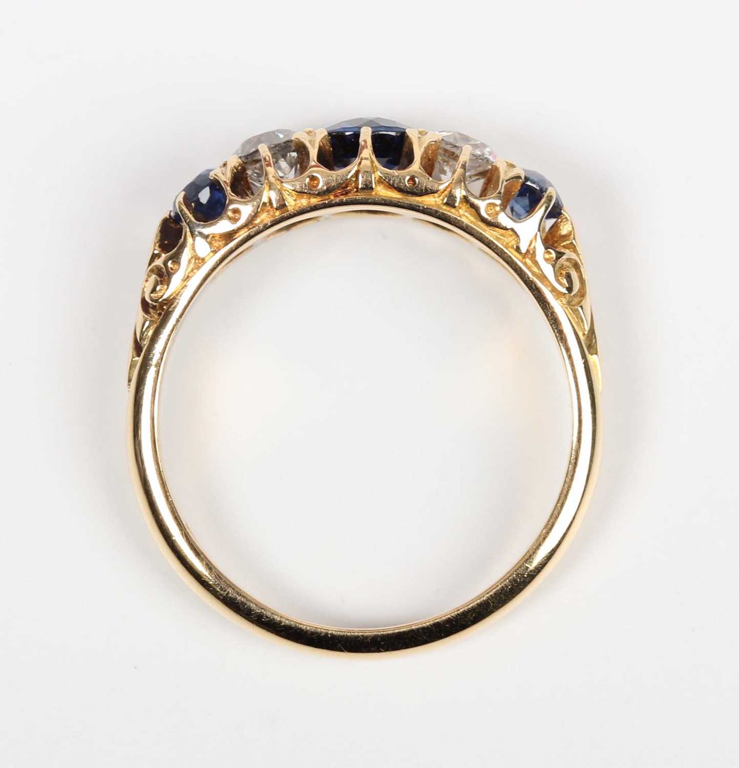 A gold, sapphire and diamond ring, mounted with three sapphires alternating with two old cut - Image 4 of 5