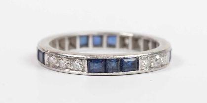 A sapphire and diamond eternity ring, mounted with rows of three circular cut diamonds alternating