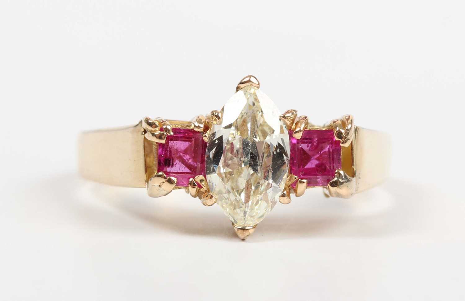 A gold, diamond and ruby ring, claw set with the marquise shaped diamond between two square cut - Image 2 of 5