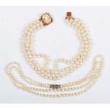 A three row choker of uniform cultured pearls on a gold, shell cameo and cultured pearl clasp,