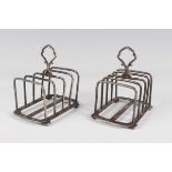 A pair of George V silver four-division toast racks on bun feet, Birmingham 1926 by Hukin & Heath,