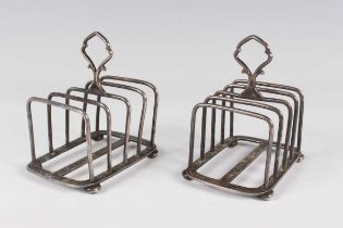A pair of George V silver four-division toast racks on bun feet, Birmingham 1926 by Hukin & Heath,